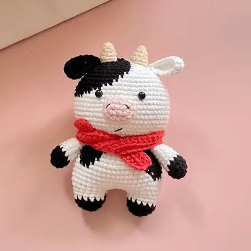 Crochet Cow Doll for the Baby Nursery: Free Amigurumi Pattern, the finished crochet build, photographed on a plain surface