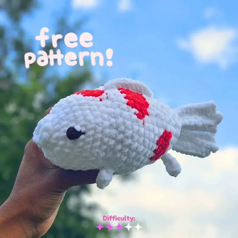 Free Crochet Koi Fish Amigurumi Pattern for Beginners, the finished crochet build, photographed on a plain surface