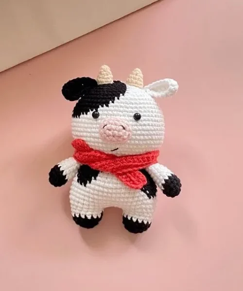 Crochet Cow Doll for the Baby Nursery: Free Amigurumi Pattern, the finished crochet build, photographed on a plain surface