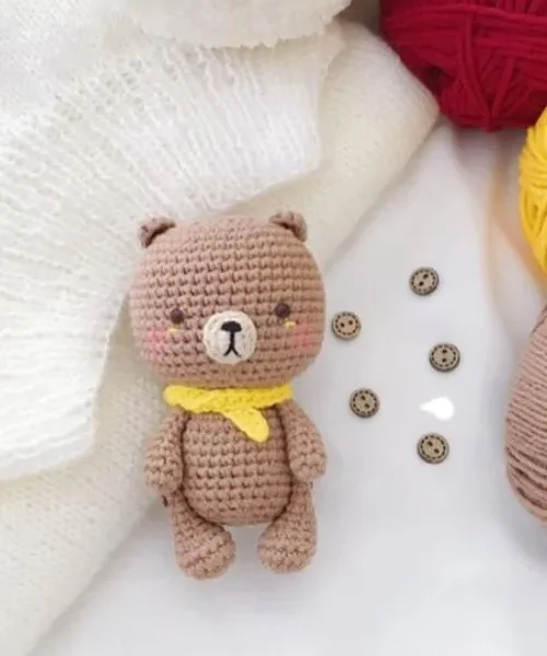 How to Crochet a Teddy Bear Amigurumi for Gift-Giving, the finished crochet build, photographed on a plain surface
