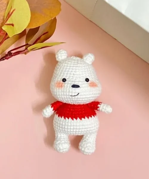 How to Crochet a Polar Bear Amigurumi for Winter, the finished crochet build, photographed on a plain surface
