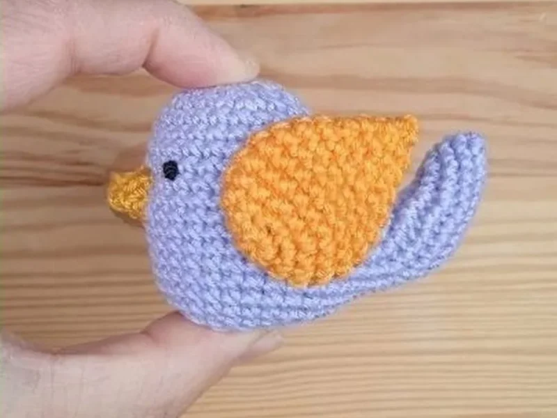 Simple Soft Crochet Bird Amigurumi — Free Beginner Pattern, the finished crochet build, photographed on a plain surface