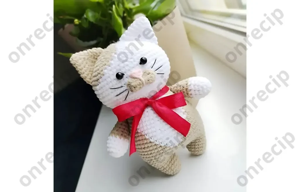 Amigurumi cat crochet pattern with oval muzzle and bow