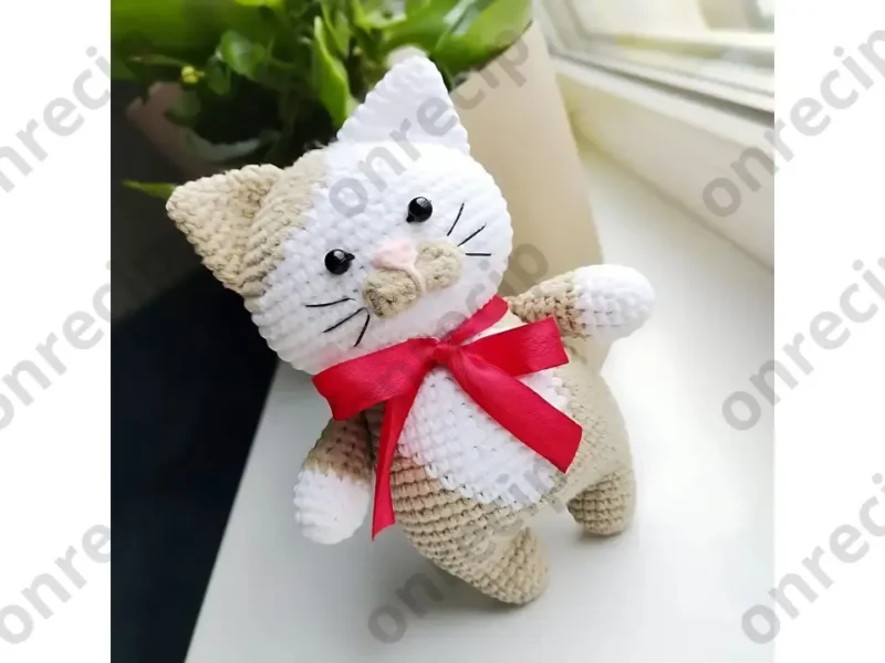 Amigurumi cat crochet pattern with oval muzzle and bow