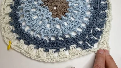 Boho puff-stitch poncho built from four crochet squares — photo 3