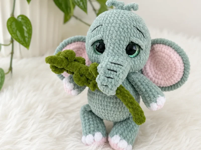Crochet baby elephant amigurumi with a curled trunk